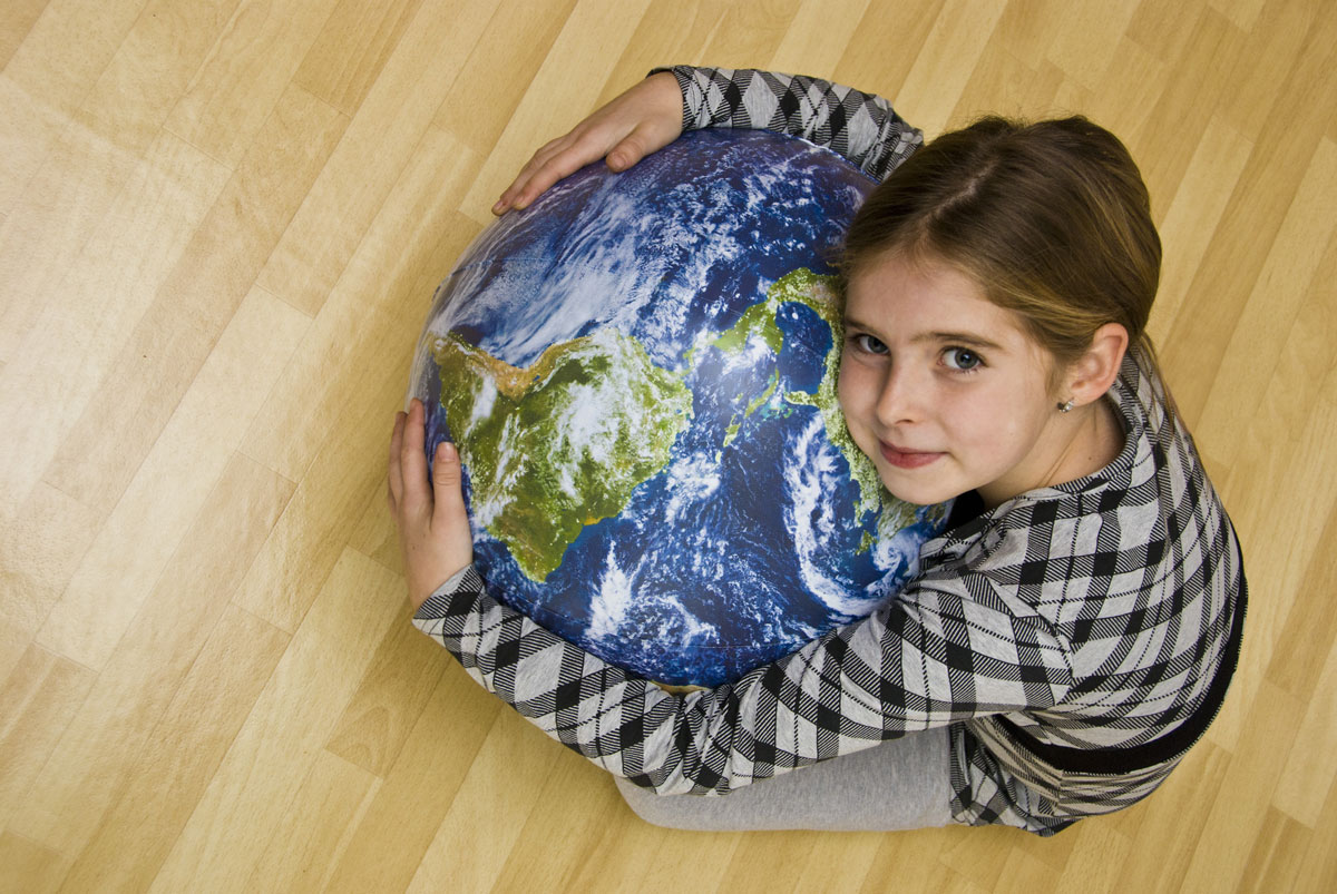 Image with a girl holding our planet